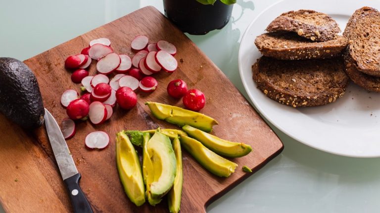 banana fruit and bread on brown wooden chopping board