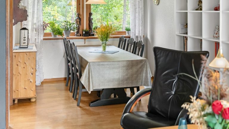 A kitchen with a table and chairs and a window