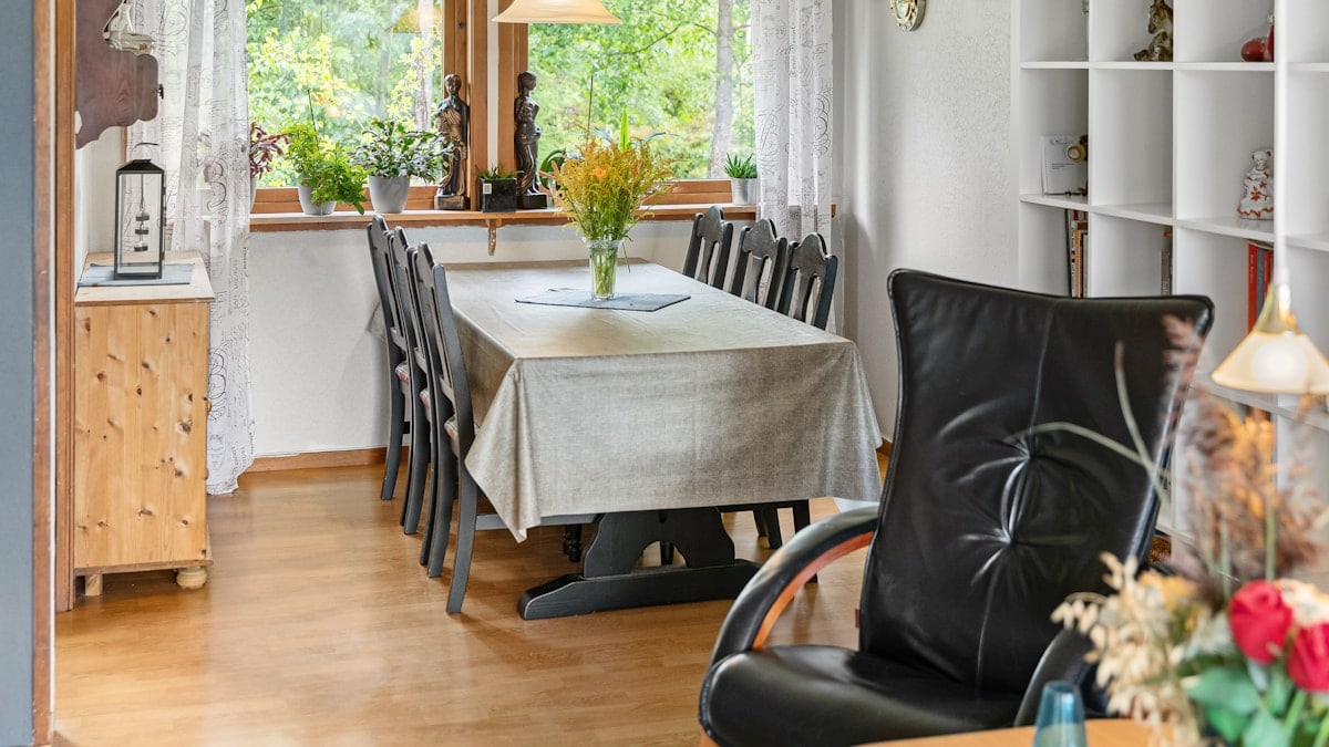 A kitchen with a table and chairs and a window